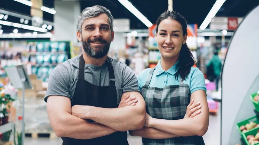 Two supermarket team members standing together on the shop floor